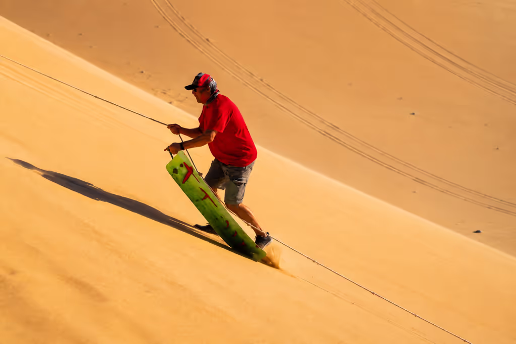 Doha Private Tour - Sandboarding during a private Doha desert safari.