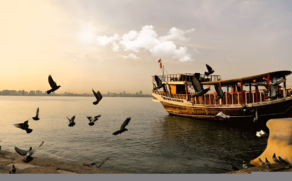 Doha Private Tour - Experience a traditional dhow boat ride across Doha Bay surrounded by scenic coastal views.