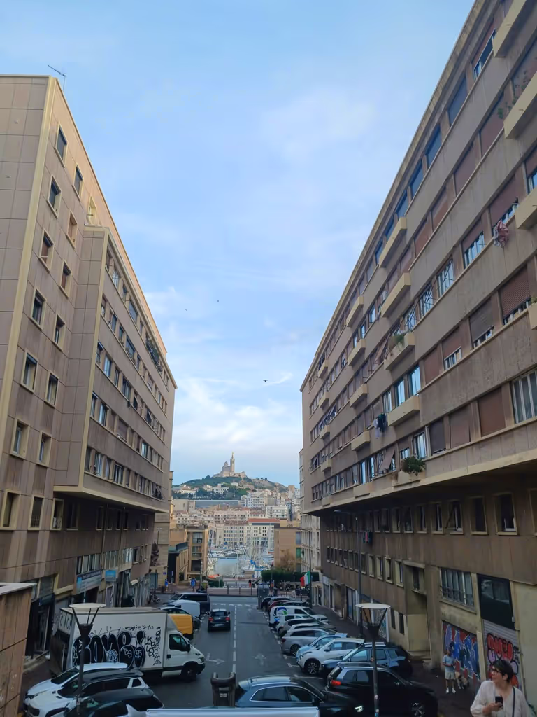 Marseille Private Tour - View of the Notre-Dame de la Garde, one of Marseille's most beloved monuments, here framed by two highly sought after residences constructed under the authority of socialist, Popular Front mayor Henri Tasso in the interwar period. 