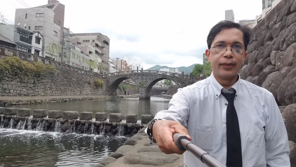Nagasaki Private Tour - Meganebashi Bridge again. Visitors often take photos on these cubic stones across the river.