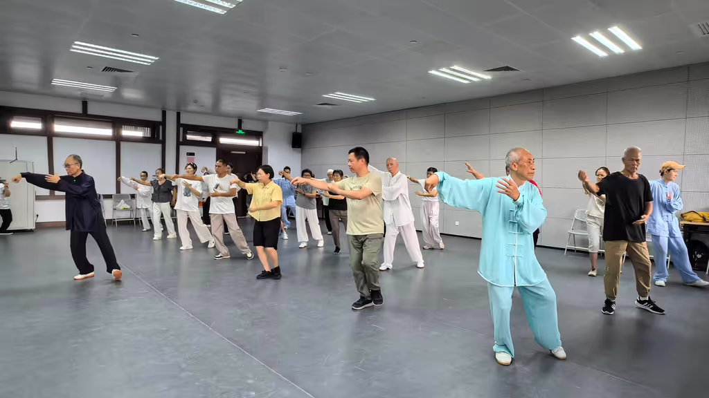 Guangzhou Private Tour - A Tai Chi master guiding students through graceful movements during a cultural class in Guangzhou.