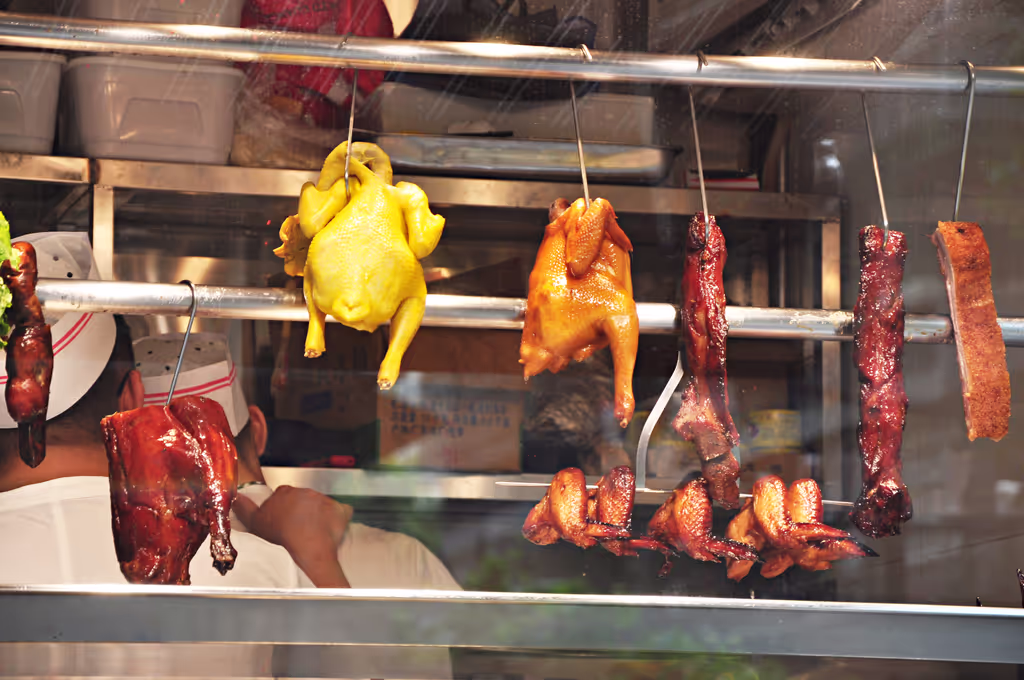 Guangzhou Private Tour - traditional Cantonese roast meats on display — tender white-cut chicken, flavorful char siu, crispy roast duck, and succulent roast goose, all local favorites in Guangzhou.