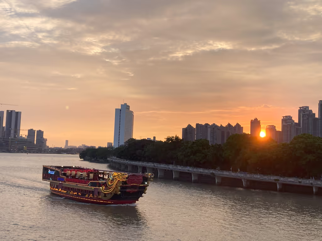Guangzhou Private Tour - Sunset cruise on the Pearl River — a peaceful moment as the boat sails through golden skies in Guangzhou.
