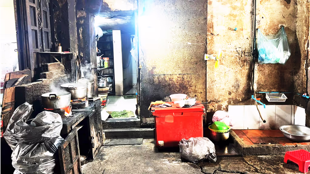 Siem Reap Private Tour - An alleyway kitchen in Phnom Penh – locals cooking rice in large cauldrons over open flames, a glimpse into the everyday life and flavors of Cambodia.