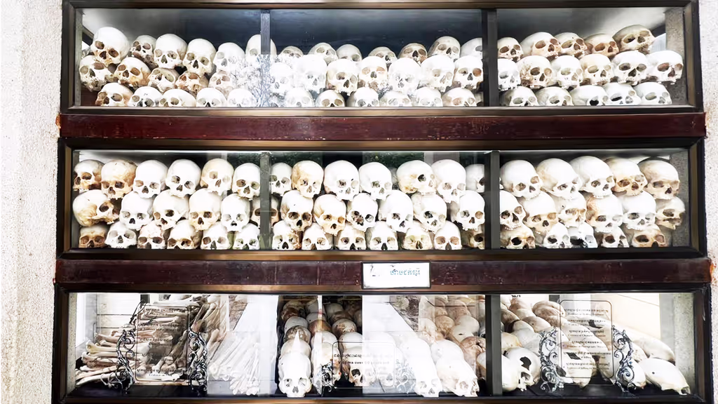Siem Reap Private Tour - Human skulls displayed inside the Memorial Stupa at Choeung Ek Killing Fields – a haunting reminder of the victims of the Khmer Rouge regime, preserved to honor their memory and to teach future generations about Cambodia’s darkest chapter.