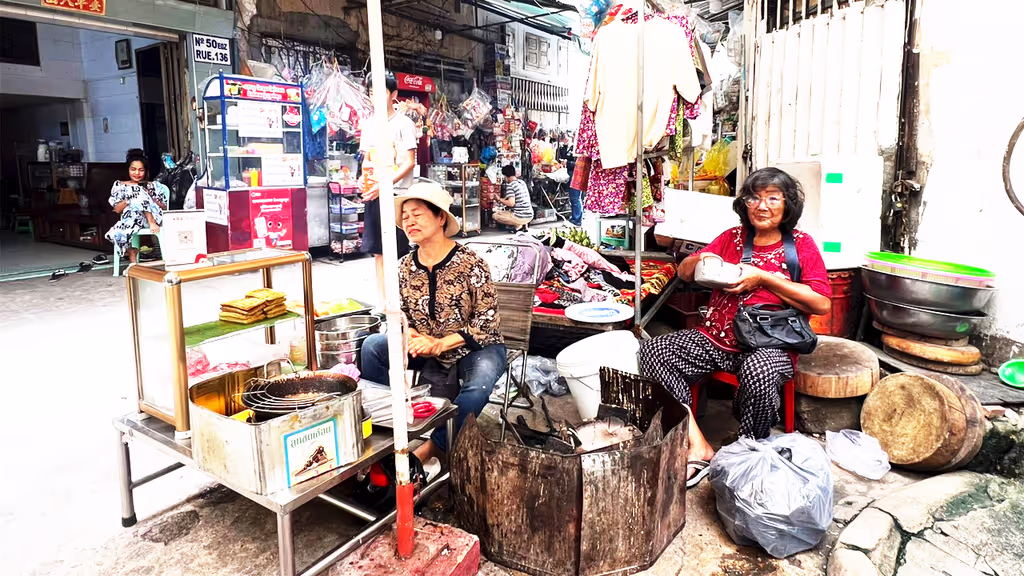 Siem Reap Private Tour - Local life in a Phnom Penh alleyway – families making and selling traditional cakes to earn a living, reflecting the resilience and warmth of Cambodia’s street culture.