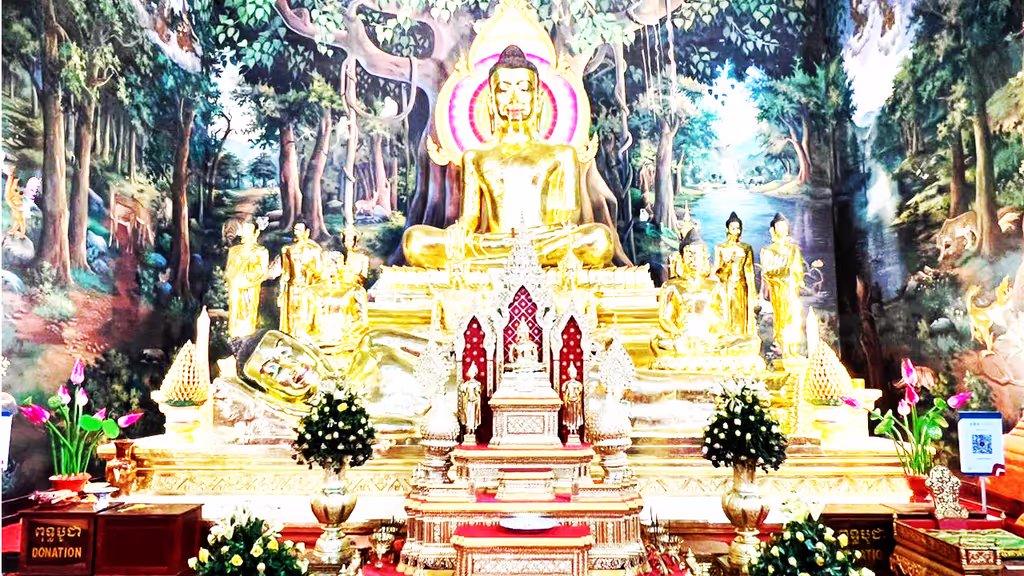 Siem Reap Private Tour - Golden Buddha altar inside a Phnom Penh pagoda – a serene shrine where the Buddha sits in radiant gold, surrounded by intricate carvings, lotus offerings, and murals depicting scenes of his life and enlightenment.