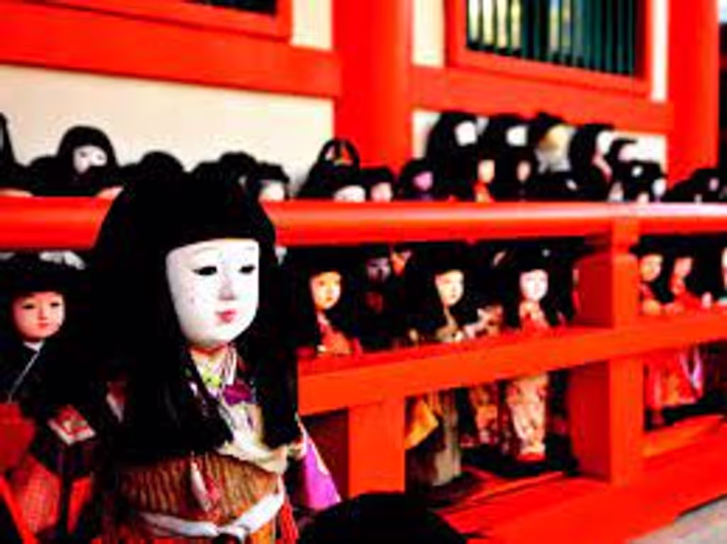 Osaka Private Tour - Many Japanese dolls are dedicated in front of the entrance of Awashima Shrine.