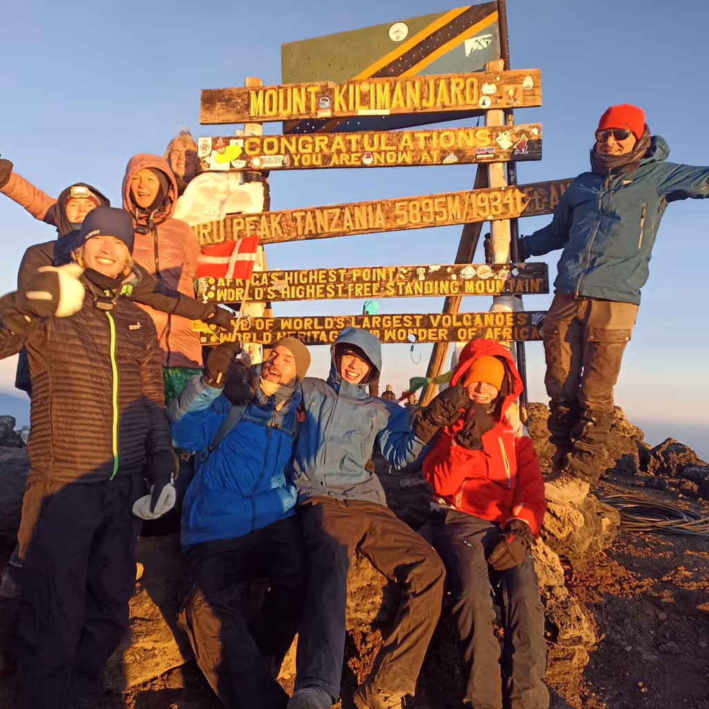 Kilimanjaro Private Tour - Group pause for photo at the summit