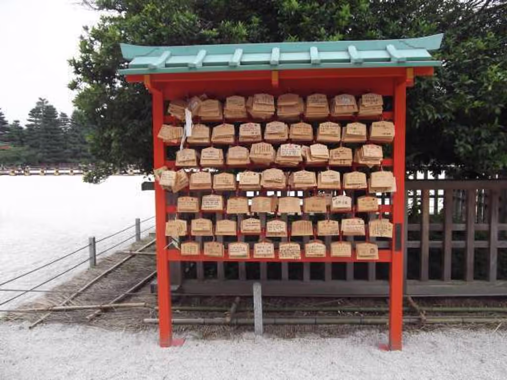 Kyoto Private Tour - "Ema" wooden wish plaques displayed on the board.
