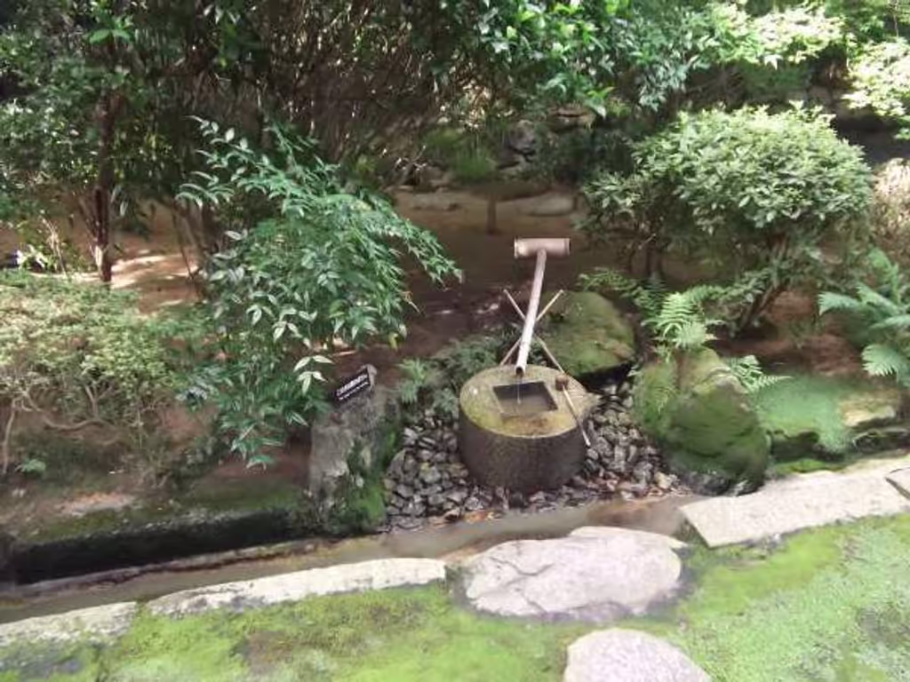 Kyoto Private Tour - "Tsukubai" stone wash-basin for the tea room.
 Said to have been contributed by a feudal lord and the great compiler of the Great History of Japan, Mito Mitsukuni, during the Edo period (1603 to 1867), this wash-basin has a unique inscription of four unfinished Chinese characters and a square notch in the center, constituting in combination four complete characters of " 吾 (I)",  "唯 (only)",  "足 (contented)",  and "知 (Know)". These words collectively mean "I learn only to be contented", or "He who learns only to be contented is spiritually rich, while one who does not is spiritually poor, even though he may be materially wealthy." This is the important concept in the Zen Buddhism spirit. 