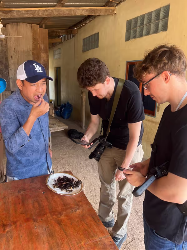 Phnom Penh Private Tour - Showing travelers how to eat deep fried tarantulas