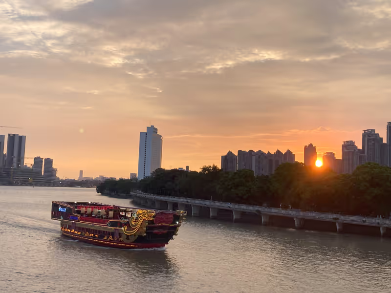 Guangzhou Private Tour - Sunset cruise on the Pearl River — a peaceful moment as the boat sails through golden skies in Guangzhou.