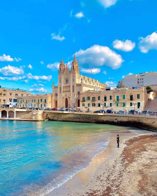Malta Private Tour - Balluta Church, officially known as the **Parish Church of Our Lady of Mount Carmel, is a stunning **neo-Gothic** Roman Catholic church located in **Balluta Bay, St. Julian’s,