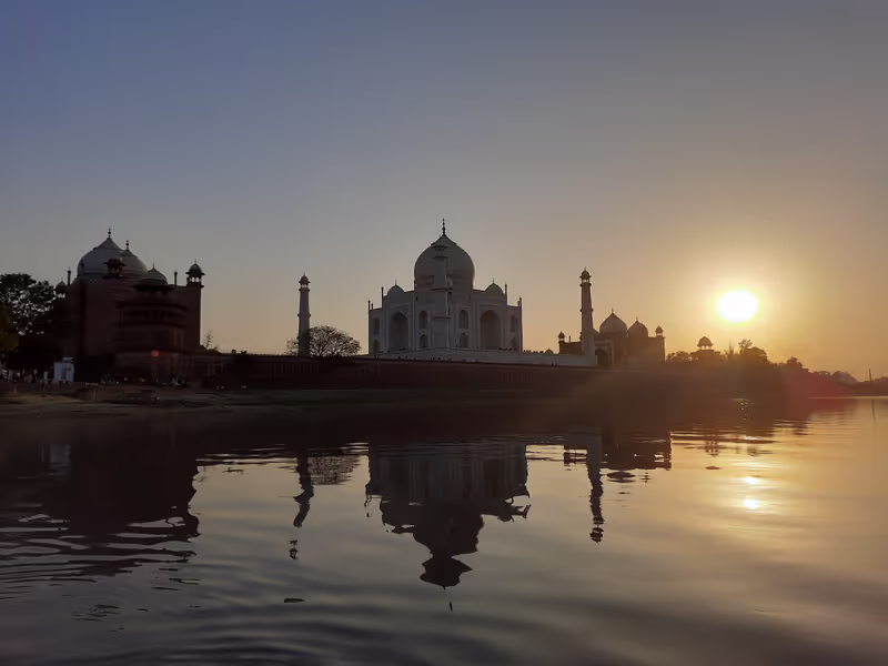 Delhi Private Tour - The sunset view of the Taj Mahal is a mesmerizing spectacle that bathes this iconic monument in a warm, golden light. As the sun dips below the horizon, the pristine white marble of the Taj Mahal takes on a serene and ethereal glow. 