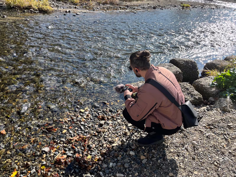Kyoto Private Tour - A guest recording the sounds of the river flowing.