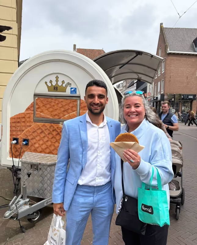 Amsterdam Private Tour - Happy guest enjoying fresh Dutch stroopwafels
