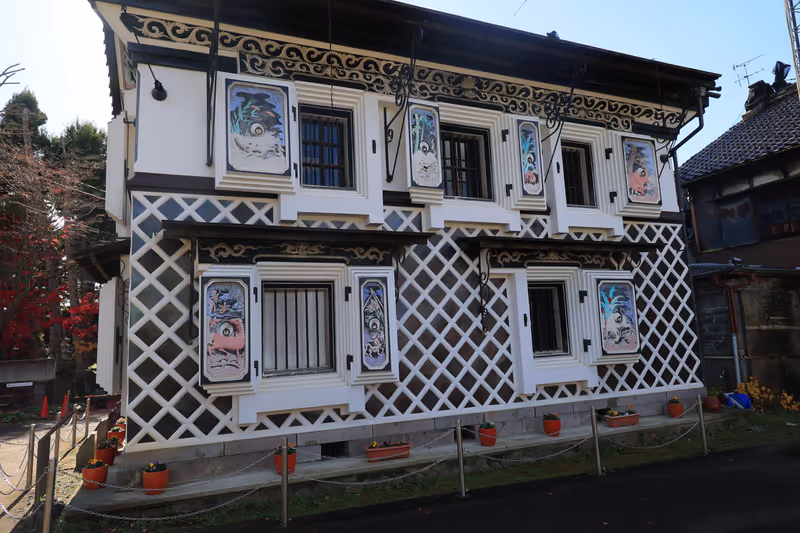 Tokyo Private Tour - Saffron Wine Storehouse with colorful reliefs of zodiac animals on the plaster wall is a registered national tangible cultural property and is located just across the street from a sake brewery in Settaya district where the brewing of "miso" "soy sauce" "sake" has been carried out for centuries.
