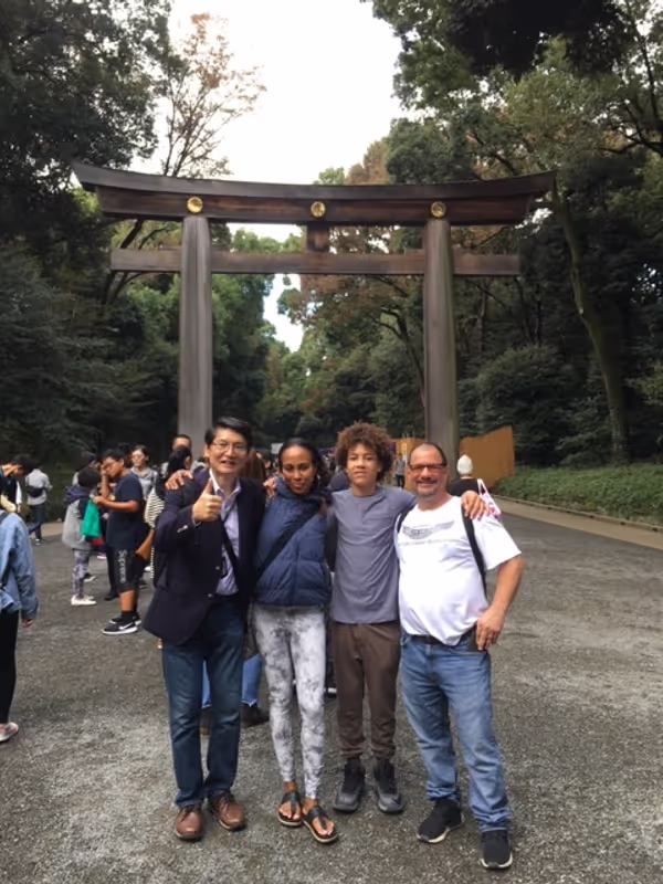 Tokyo Private Tour - My guests in front of Torii of Meiji Jingu Shrine. Torii is an entrance gate to the main hall of the shrine.